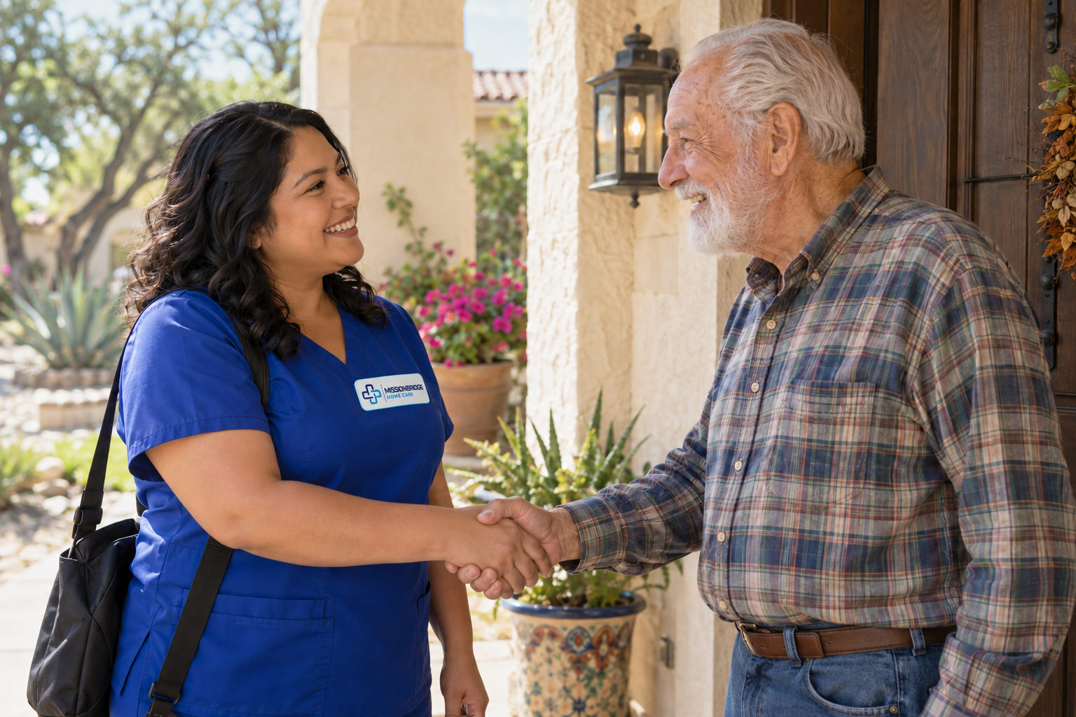 Illustrative companion in branded royal-blue scrubs greeting an older man at home